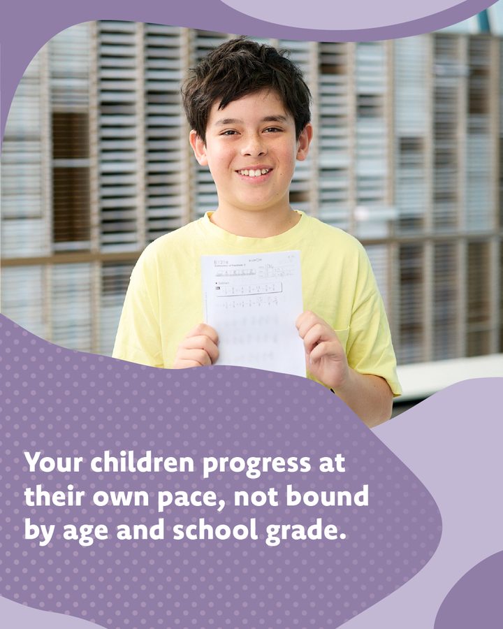 Kumon explainer: Your children progress at their own pace, not bound by age and school grade. A smiling boy holds up a worksheet.